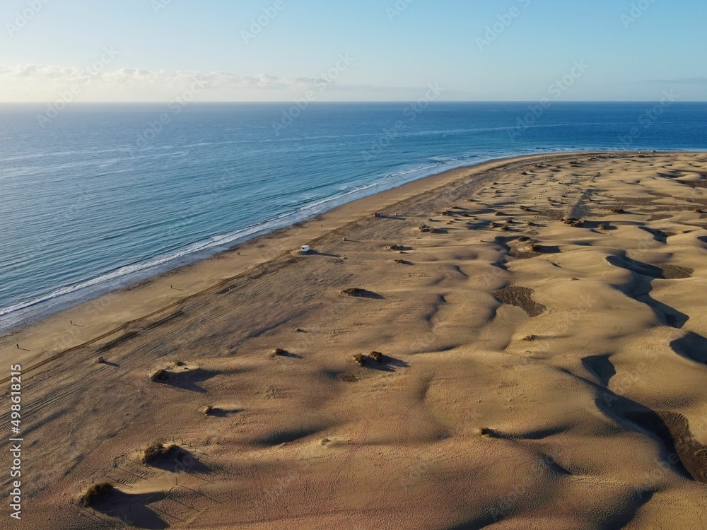 Aerial drone landscape of Maspalomas golden sand dunes at sunrise, Gran Canaria, Canary Islands, Spain