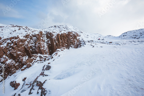 Snow desert and rocks. Winter landscape near Teriberka. Russia