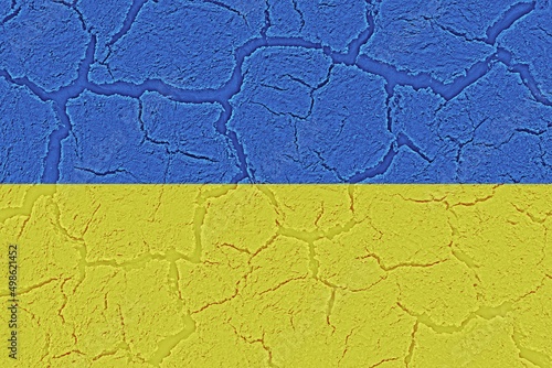 Cracked destroyed worn out national flag of Ukraine in the course of war and crisis. Background, texture and victim resistance symbol