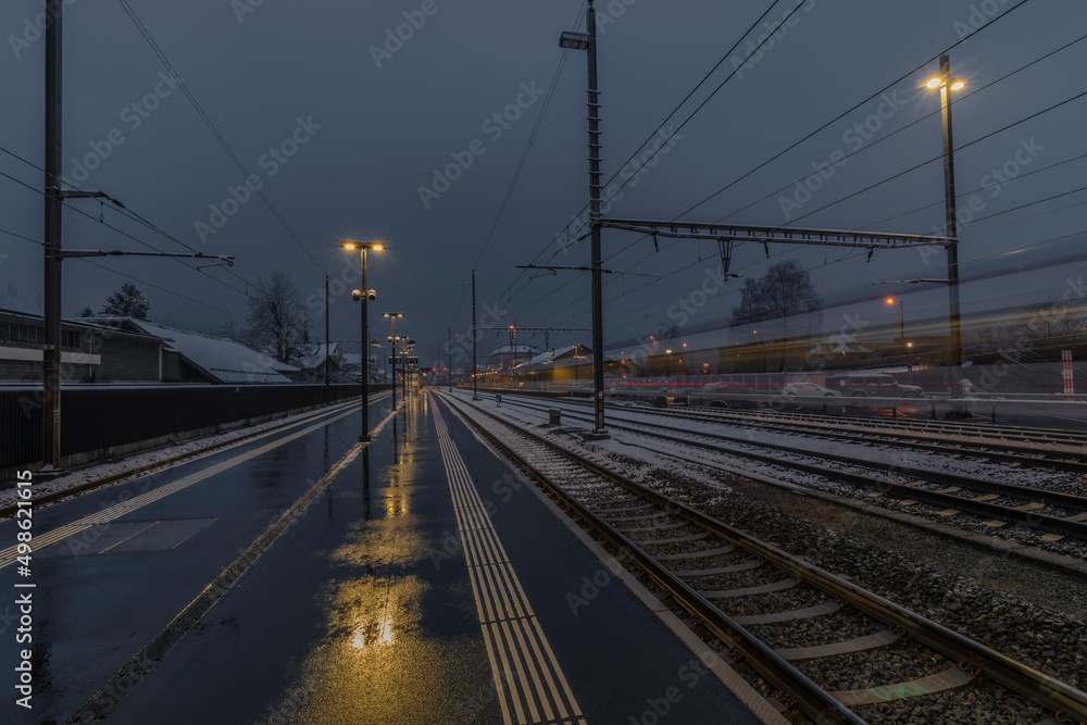 Very bad weather in Brunnen station in spring snowy morning