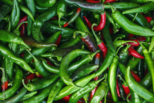 background of ripe natural organic red and green chili peppers. © Andrii