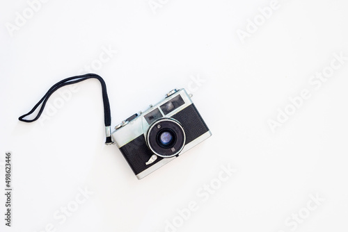 Old film photo camera on a white background. photo