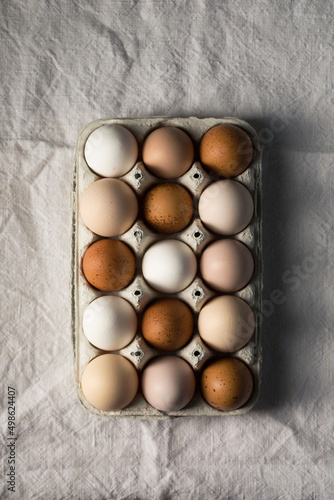 Tray with colorful farm eggs, top view
