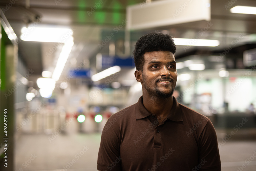 Portrait of handsome black man at train station during night Portrait of handsome black man at train station during night