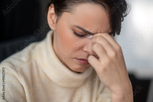 A close up of a woman feeling tired and unhappy