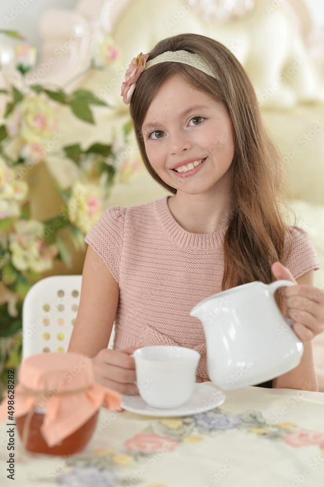 Smiling little girl holding big cup of tea Smiling little girl holding big cup of tea