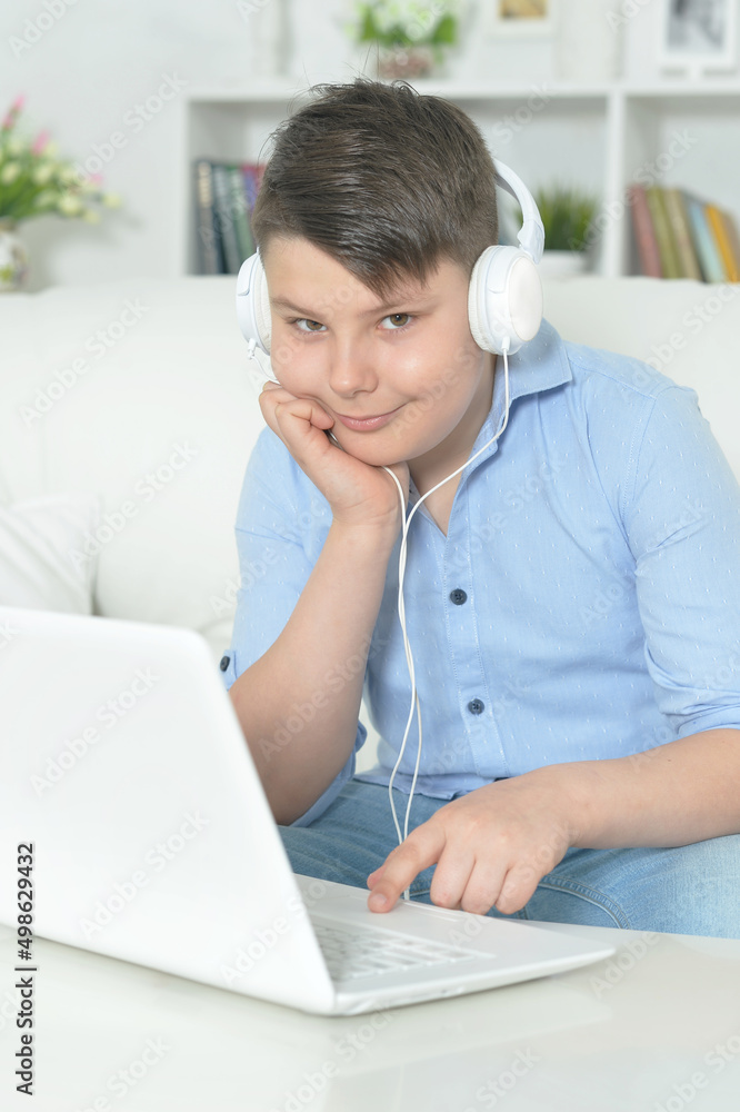 Portrait of boy with headphones using laptop Portrait of boy with headphones using laptop