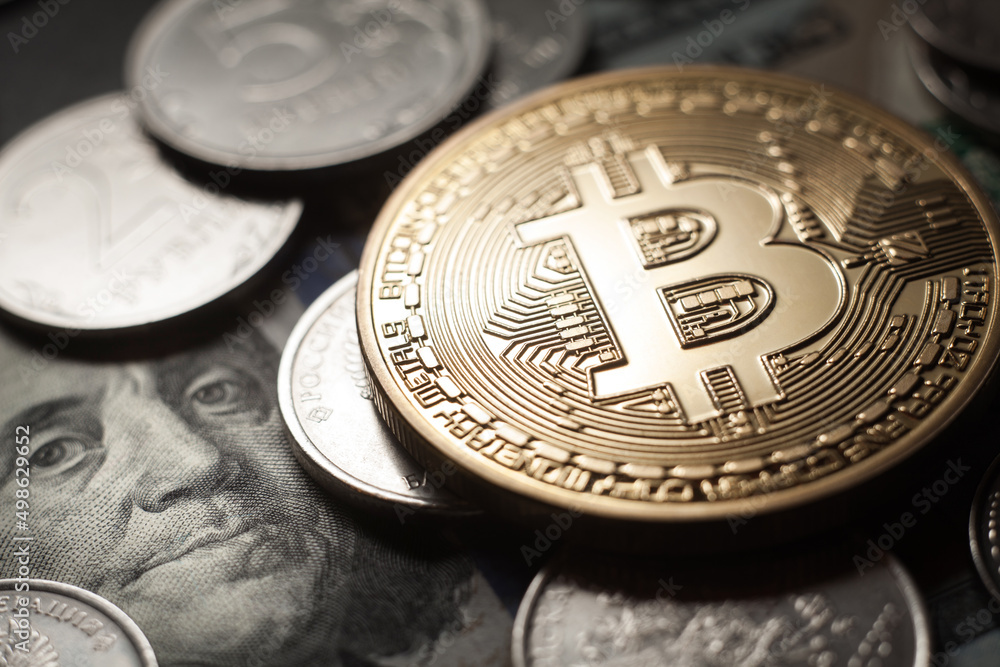 Bitcoin Crypto currency coin virtual money and Russian rubles on dollars banknotes. Close up image of Bitcoin with Russian Rubles. Bitcoin Crypto currency coin virtual money and Russian rubles on dollars banknotes. Close up image of Bitcoin with Russian Rubles.
