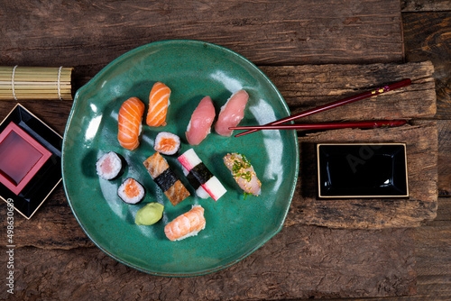 nigiri sushi and hossomaki - salmon, tuna, kani-kama, skin, shrimp - sake - chopsticks - soy sauce photo