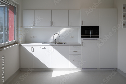 in the white room is installed a kitchenette photo