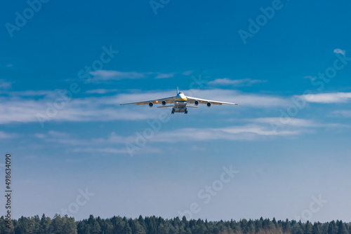Huge cargo plane is approaching the runway and is about to land on an airport in Ljubljana, Slovenia. Freighter jet descending towards the airfield.