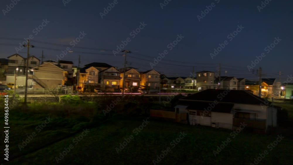 Panning timelapse of cars zipping by suburban residential area in early evening Panning timelapse of cars zipping by suburban residential area in early evening
