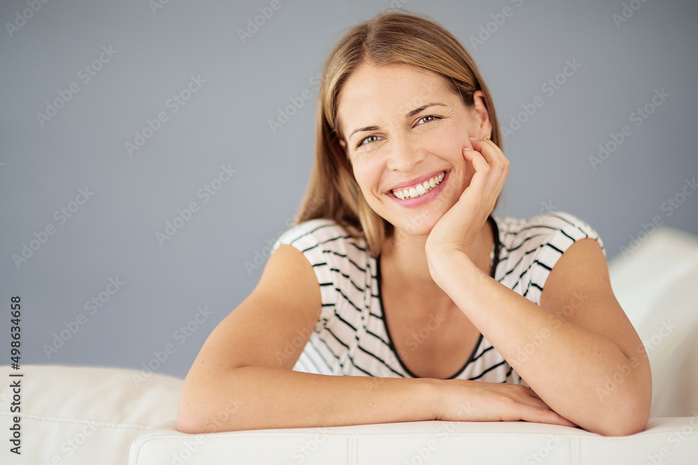 Home is where her heart is. Portrait of a young woman relaxing on the sofa at home. Home is where her heart is. Portrait of a young woman relaxing on the sofa at home.