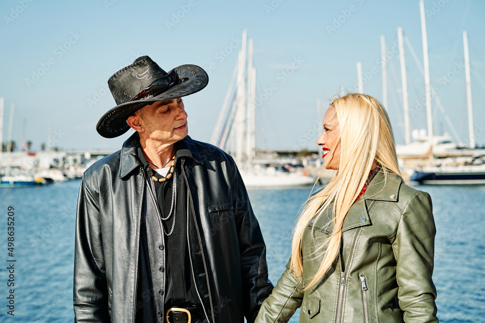 Romantic middle-aged couple strolling along the harbor