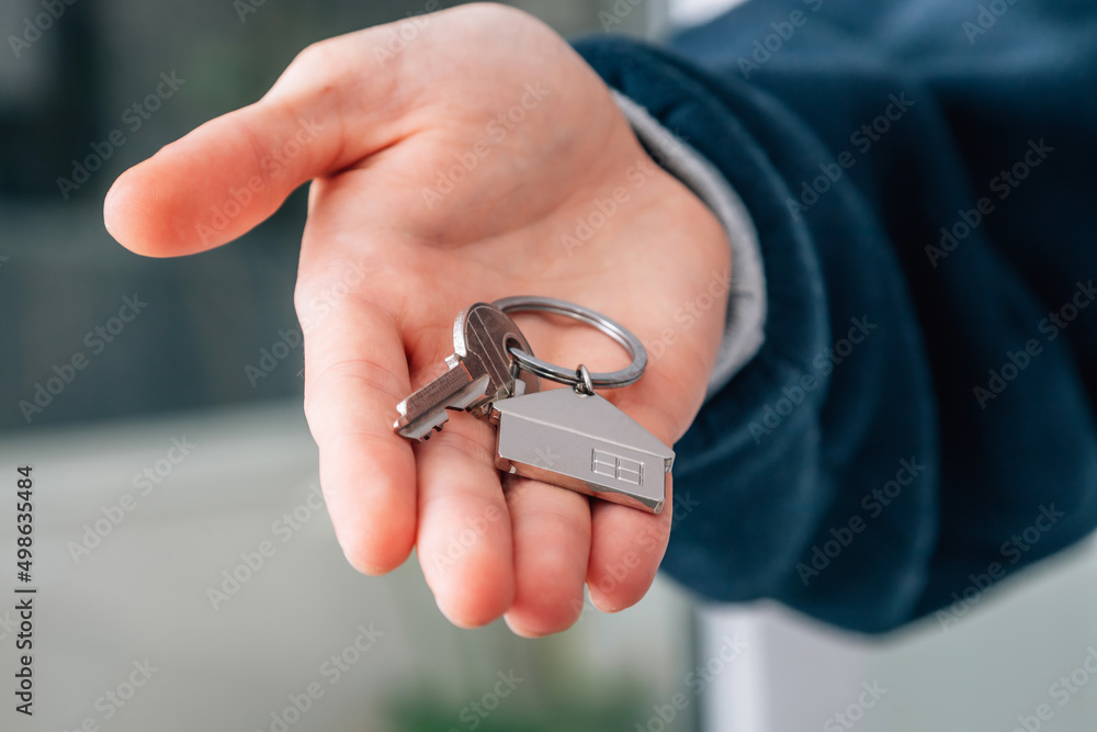hand with keys and keychain from house or apartment