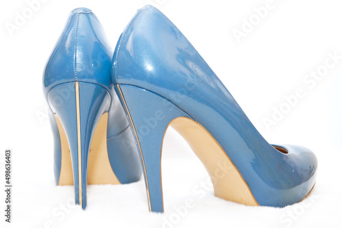 Blue sexy high-heeled shoes on a white carpet. photo