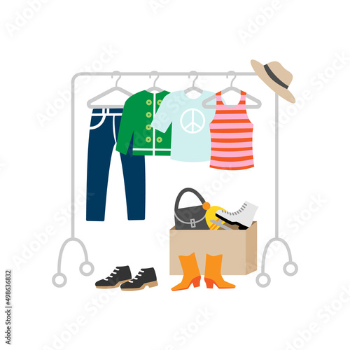 Second hand clothes hanging on rack. Flea market goods on sale.