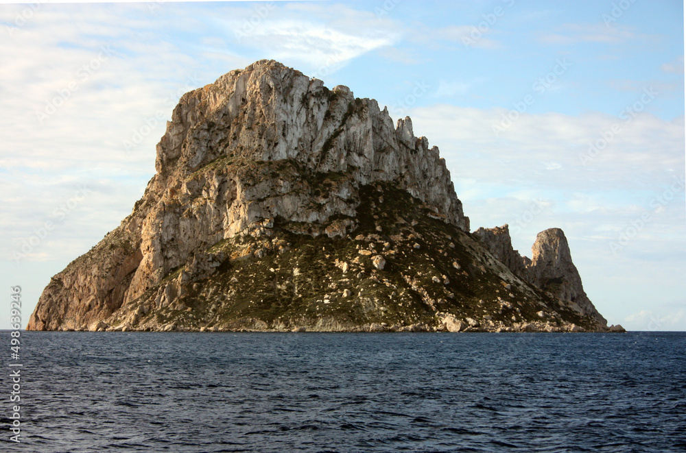 The small Balearic rocky islet of Es Vedra in the Ibiza Sea The small Balearic rocky islet of Es Vedra in the Ibiza Sea