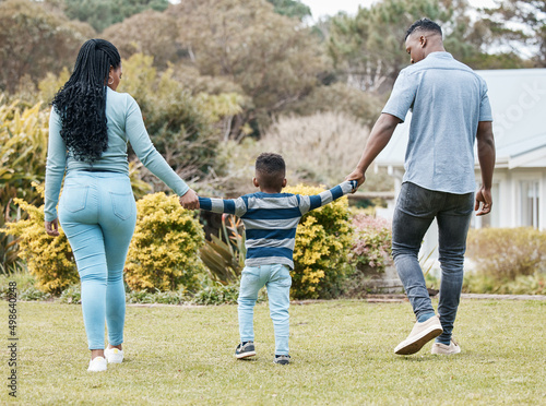 Family is everything. Full length shot of an unrecognisable couple bonding with their son in the garden.