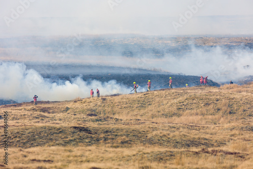 Fire fighters dealing with a large grassfire on an upland moors in Wales photo