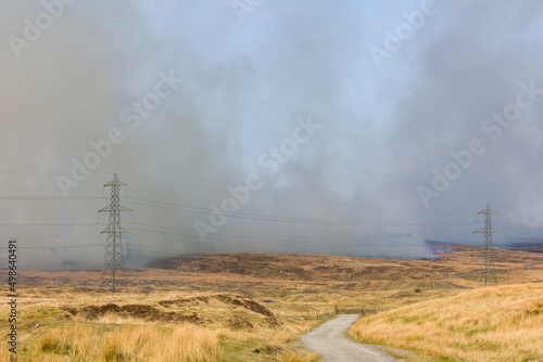 Fire fighters dealing with a large grassfire on an upland moors in Wales