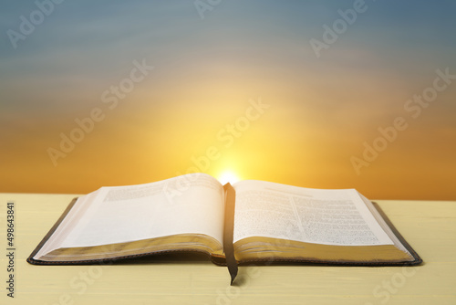 Open Holy Bible on table outdoors