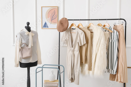 Rack with stylish clothes in modern studio of fashion stylist photo