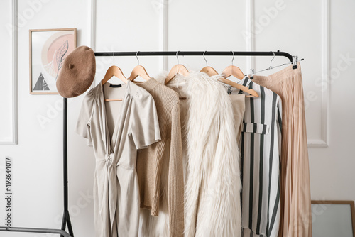 Canvas Print Rack with stylish clothes in modern studio of fashion stylist