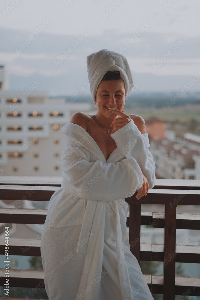 girl in a bathrobe on the balcony on vacation girl in a bathrobe on the balcony on vacation