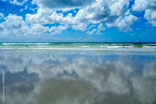 clouds over the reflective beach
