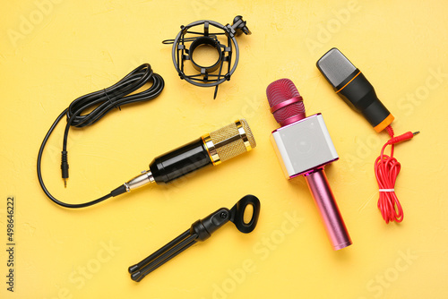 New modern microphones on color background