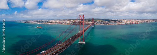 Aerial Panoramic photography of the 25 de Abril bridge in the city of Lisbon over the Tajo River .