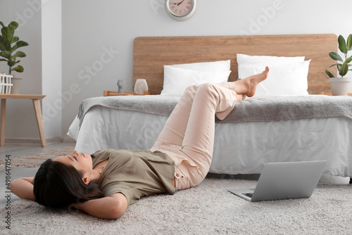 Young barefoot woman lying ...