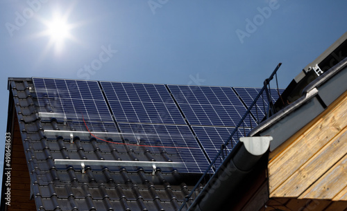 Installation of solar panels on the roof of a house. Metal mounting, construction. Conceptual image.