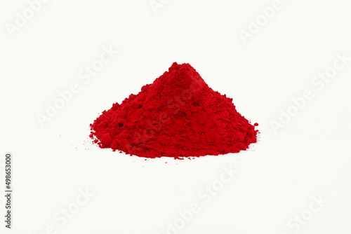 heap of kumkum powder use for indian traditional god worship and applying a bindi(mark) on forehead of woman for good luck on white background photo