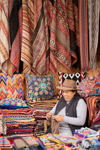 Peruvian woman weaving baby alpaca wool in a handicraft shop