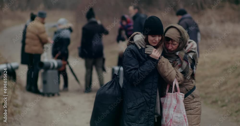 Refugee Woman Consoling Crying Daughter During War. Refugee Woman Consoling Crying Daughter During War.