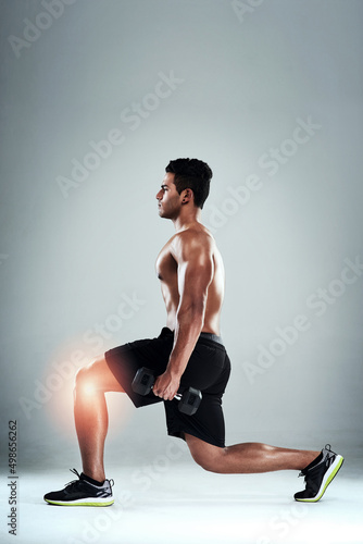 Lunges can put strain on your knees. Studio shot of a sporty young man working out with an injured knee against a grey background.