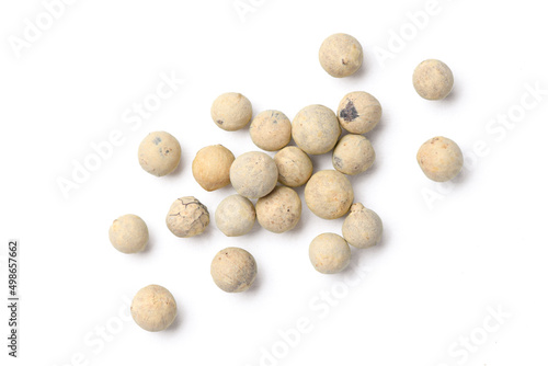 Flat lay of white peppercorns (white pepper) isolated on white background.