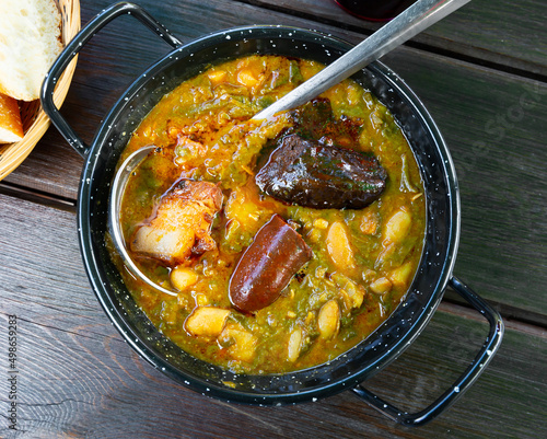 Delicious Pote asturiano with stewed beans, cabbage, potatoes, bacon,  photo