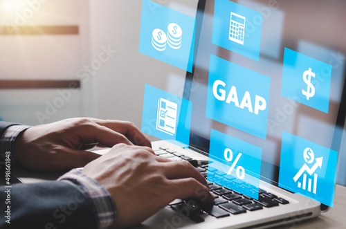 Foto man hand using laptop virtual screen GAAP Generally Accepted Accounting Principles icons and symbols