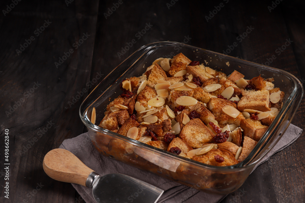 Bread pudding or puding roti tawar topping with almond slice and dried cranberry. Bread pudding or puding roti tawar topping with almond slice and dried cranberry.