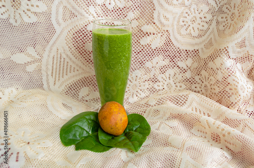 A Drinking Glass Filled With Spinach And June Plum Juice