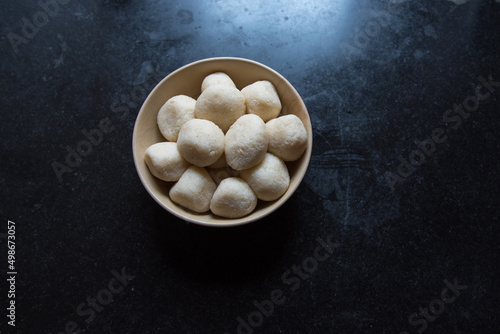 Indian dessert item rasgulla or rosogolla in a bowl. Top view. photo