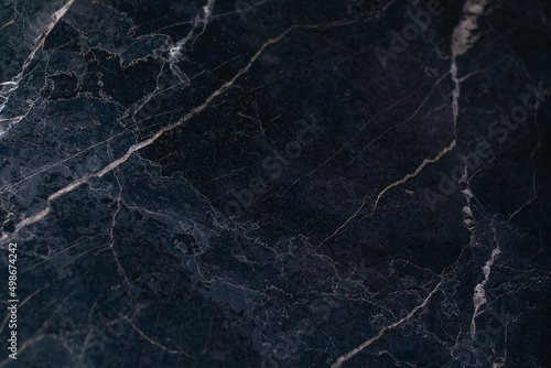 Gray marble background with light veins. Focus on the left and bottom. Horizontal view.