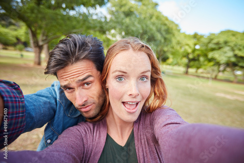 We still fall in love every day. Portrait of a young couple taking a selfie while out at the park.