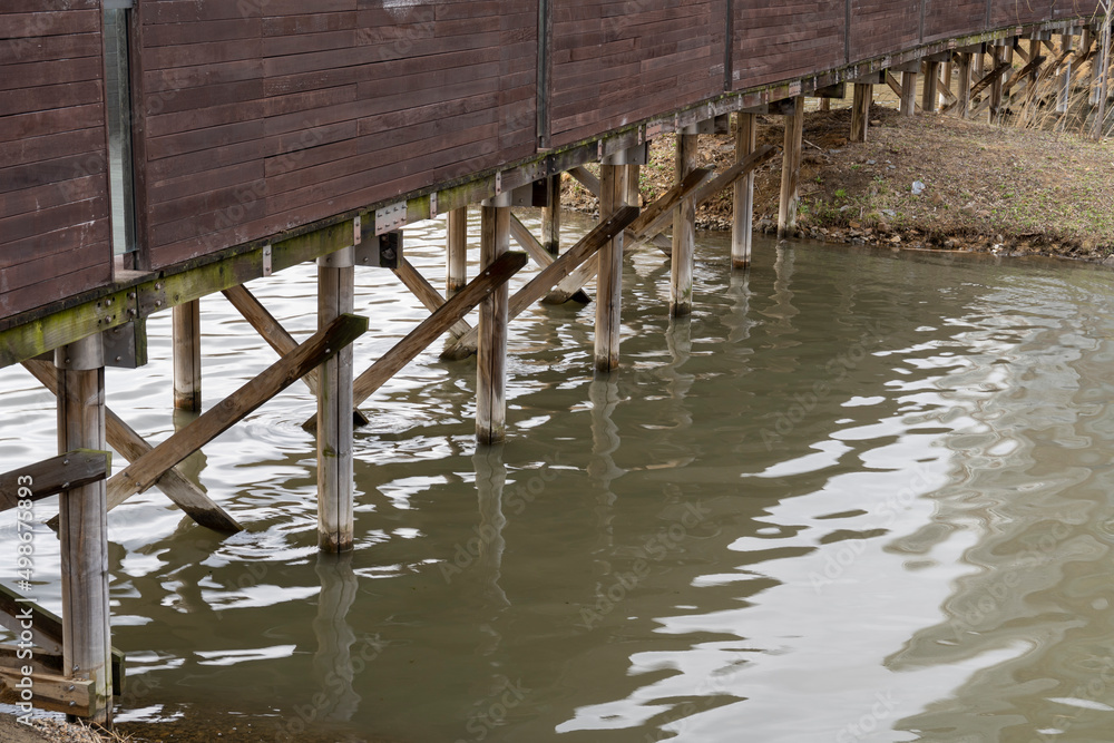 Scenery under a wooden bridge over the river Scenery under a wooden bridge over the river