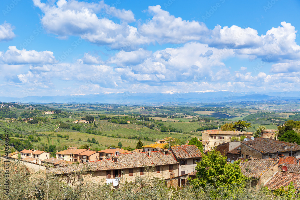 View of the rooftops of an Italian village and the Tuscan countryside