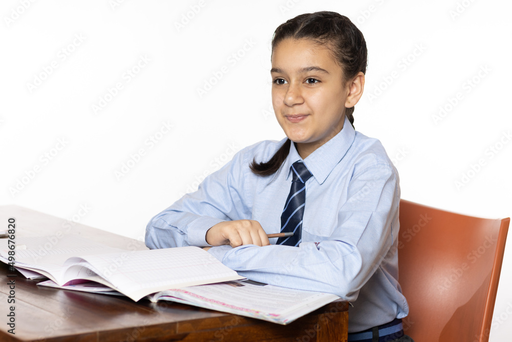 young girl of primary school sitting in classroom attentively listening isolated on white background young girl of primary school sitting in classroom attentively listening isolated on white background