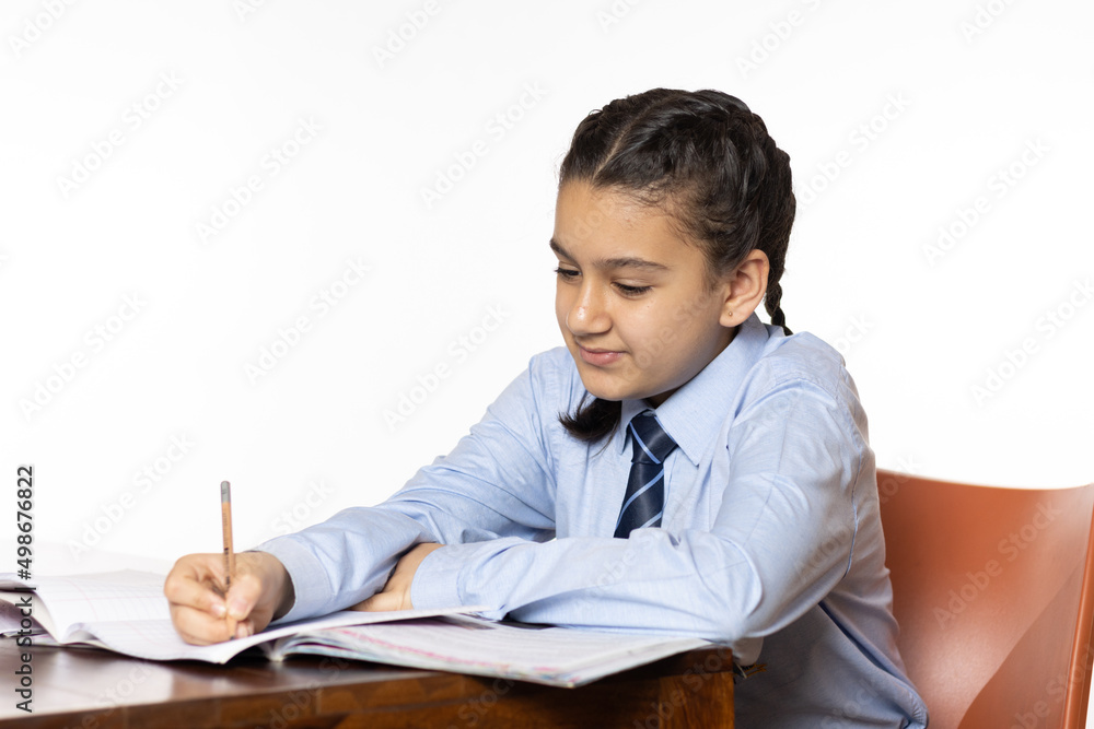 young girl of primary school sitting in classroom attentively listening side view isolated on white background young girl of primary school sitting in classroom attentively listening side view isolated on white background